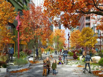 A lively street scene features people enjoying a colorful autumn day. The street is lined with vibrant red, orange, and yellow trees. Families and individuals stroll along the path, some sitting and talking on benches. The atmosphere is cheerful, with a mix of adults and children engaging in various outdoor activities. Buildings in the background have modern designs, adding to the urban setting.