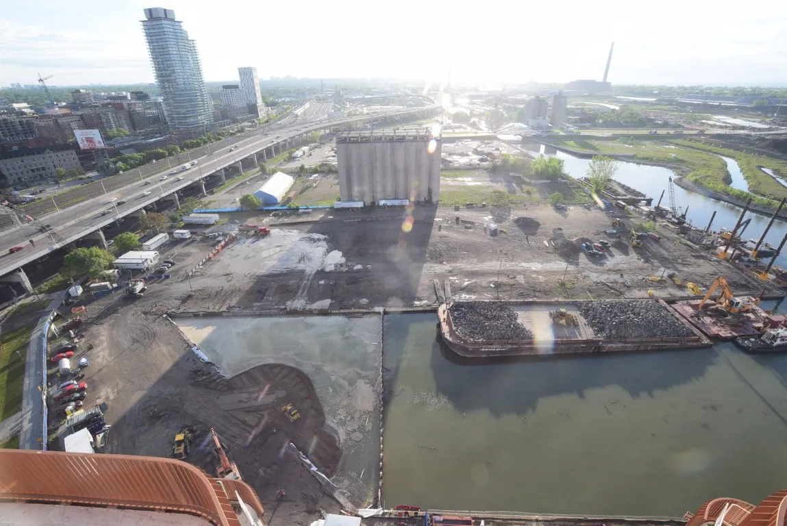 Aerial view showing further infill at Parliament Slip, with cranes and equipment compacting newly placed materials. 3/5