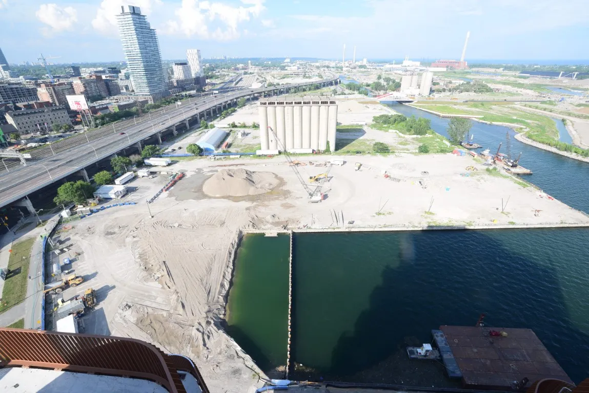 Parliament Slip nearing completion of lakefill, with sand piles and site grading underway in preparation for future development. 4/5