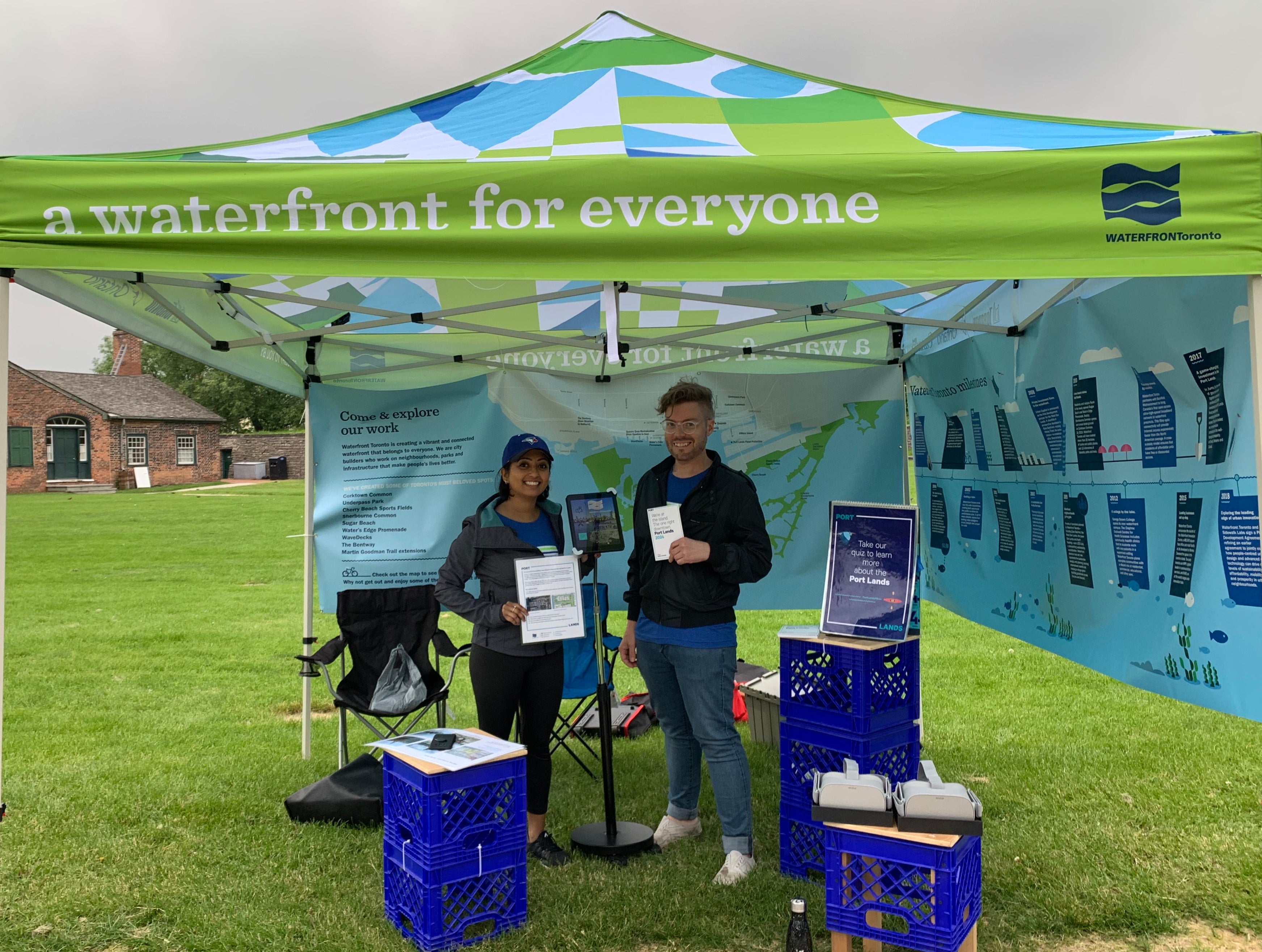 A man and woman standing in a tent at a public park