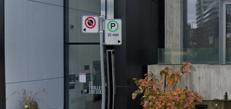 a close up of street signs showing parking restrictions