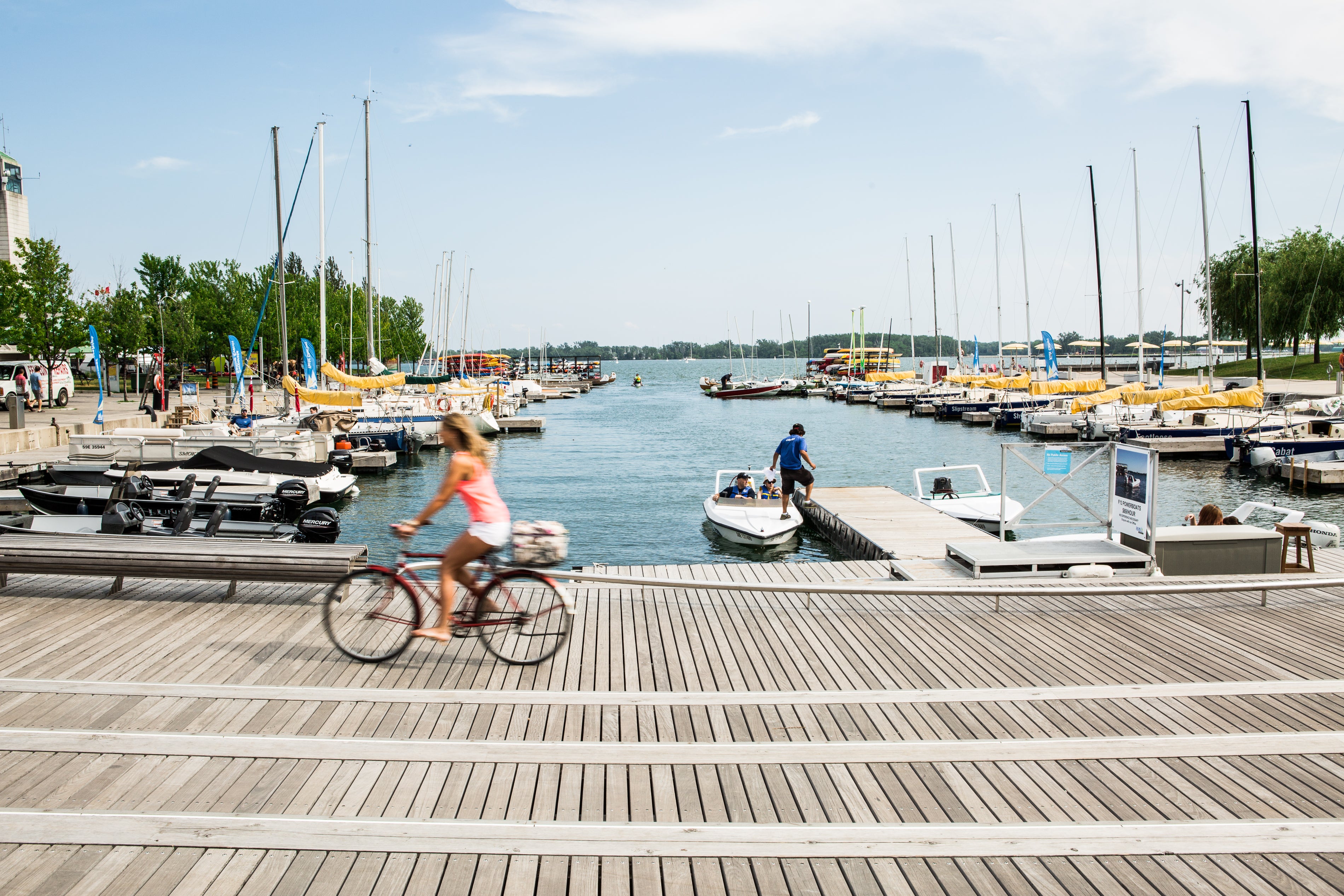 a view of the Rees WaveDeck next to Lake Ontario with boats and canoes in the water