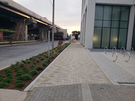 photo showing sidewalk and road work on Lake Shore Boulevard East adjacent to a condo building and the Gardiner Expressway