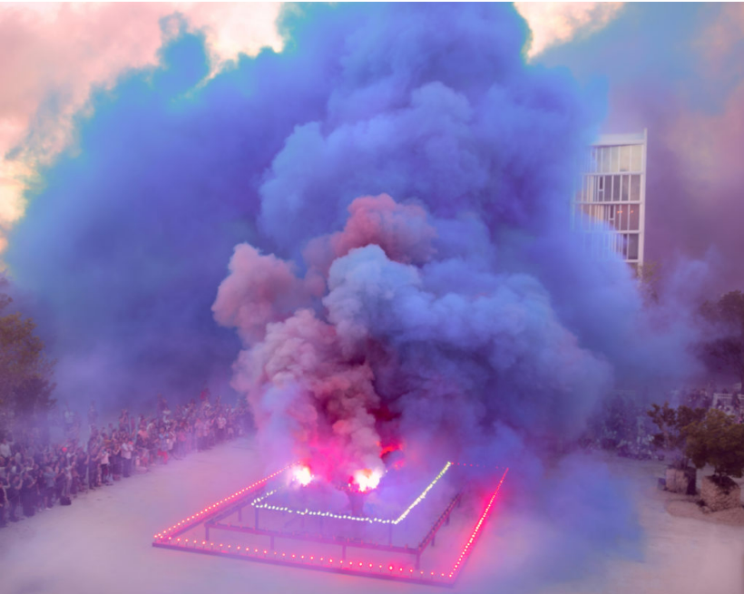 a photo showing an public art exhibition with colourful, blue and purple clouds of smoke