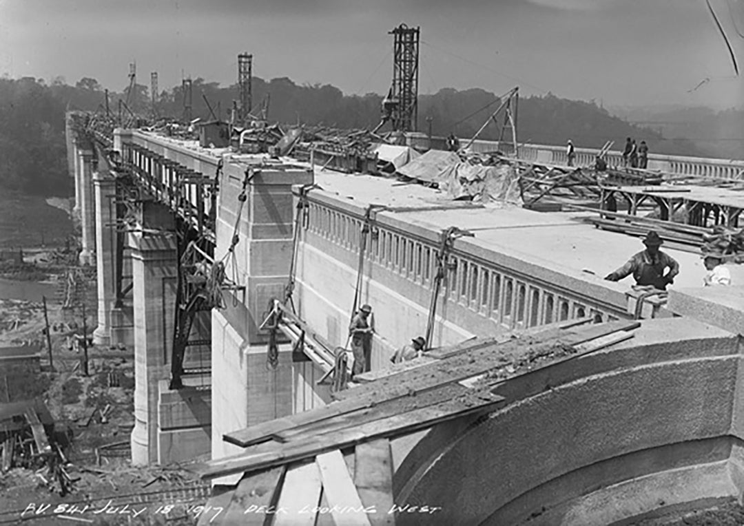People work on the construction of the Bloor St. Viaduct in a black and white image.