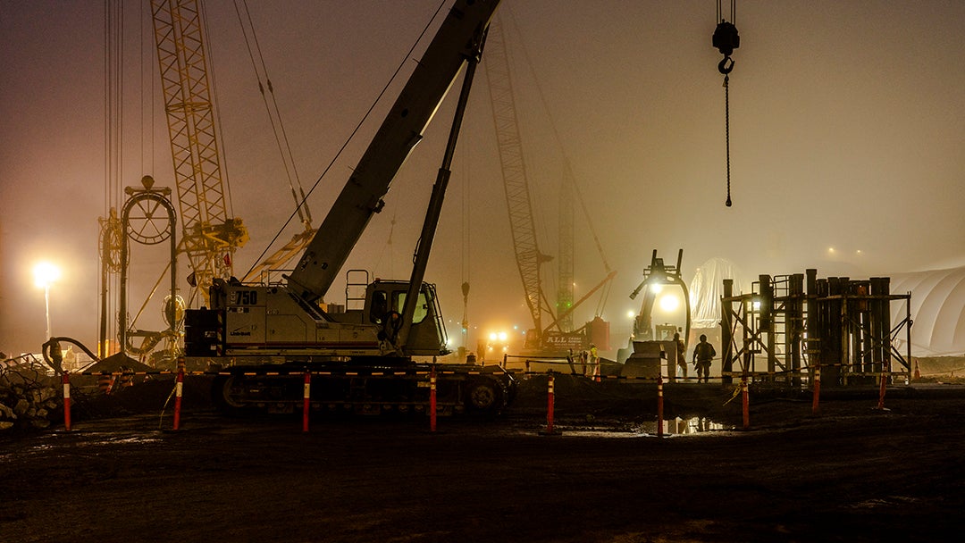 Construction equipment works at night. 