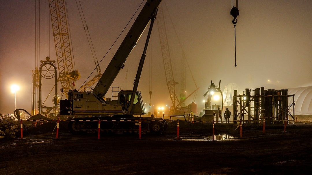 Construction equipment works at night.