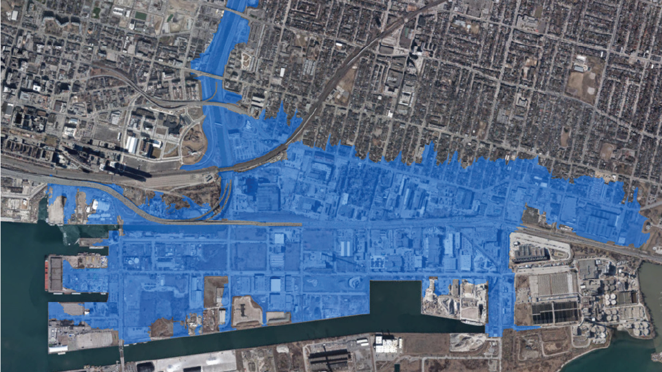 Satellite image of a city's downtown overlaid with floodplain illustration