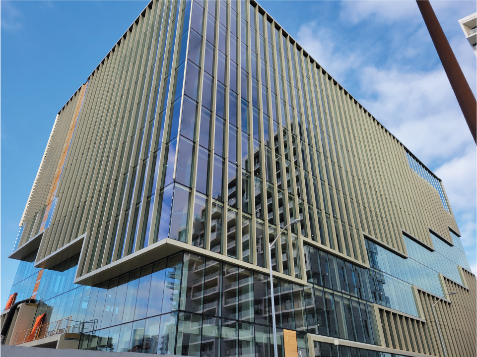 Glass and wooden exterior of a building under construction.