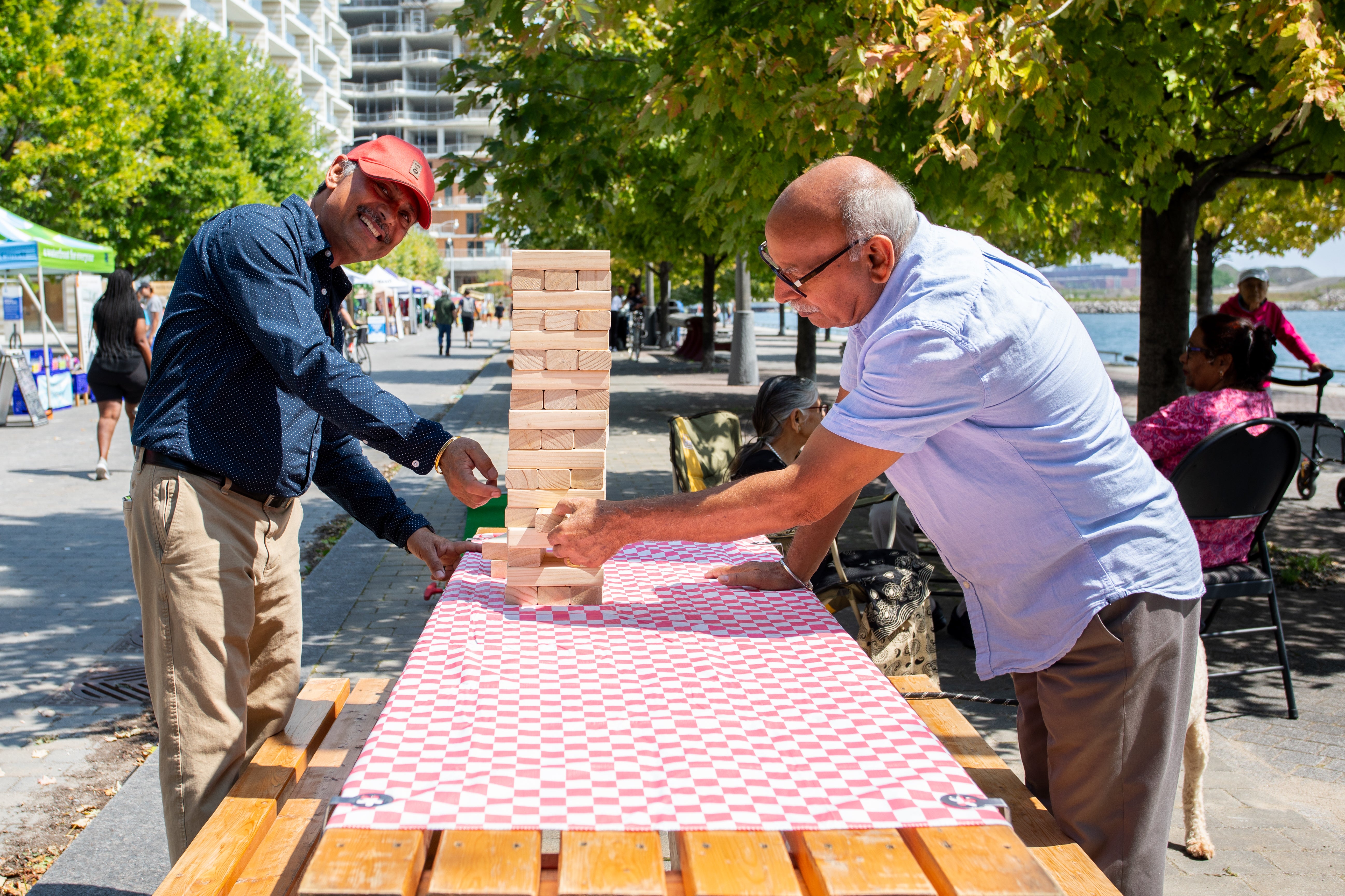 Two people play an interactive game on the waterfront.