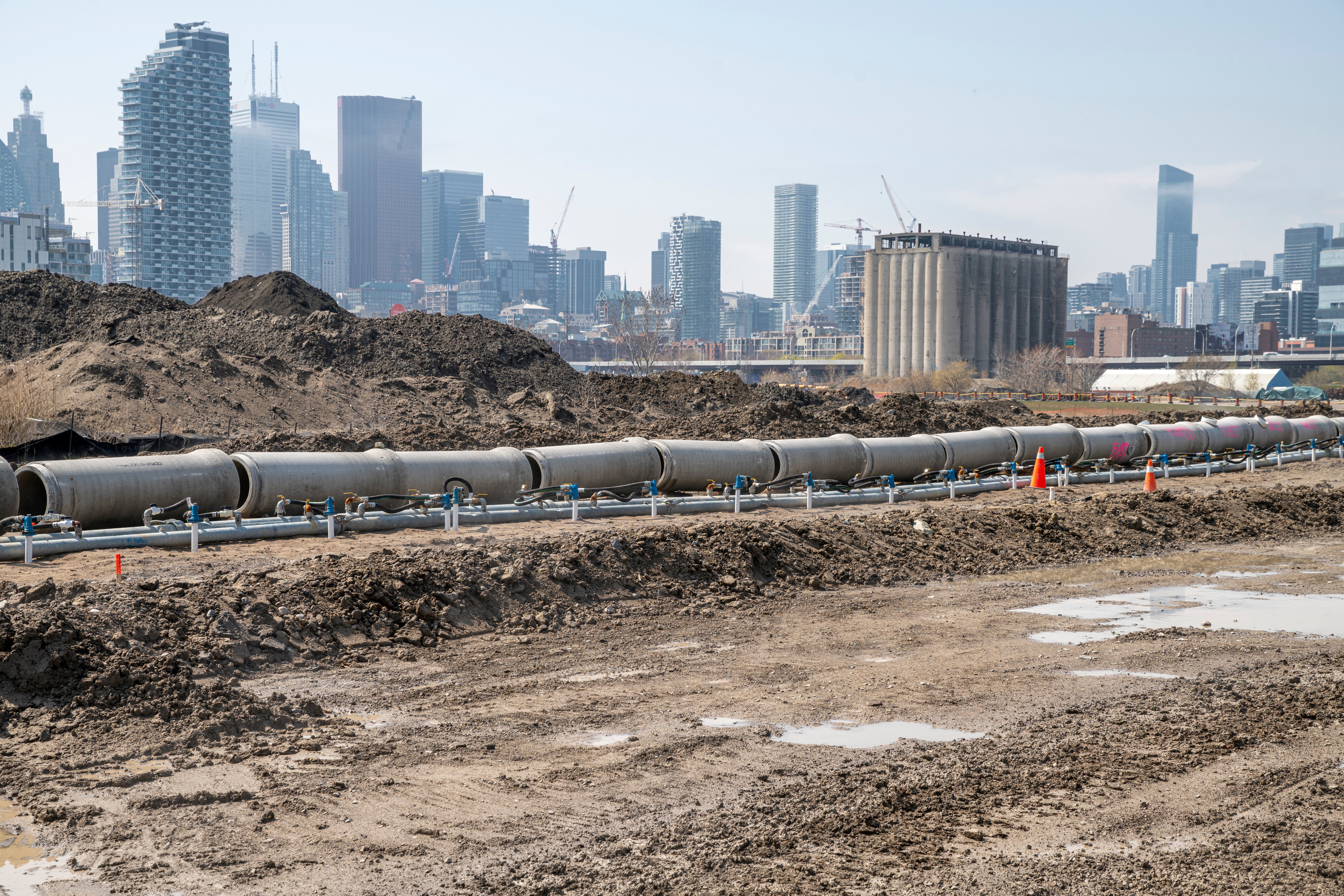 Large industrial pipes in a line in a construction site.