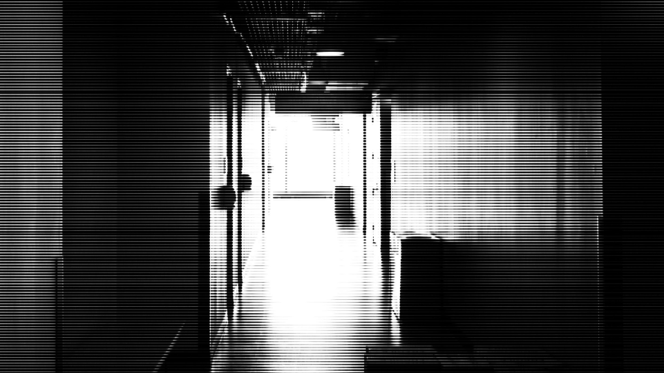Black and white image of a hallway. 
