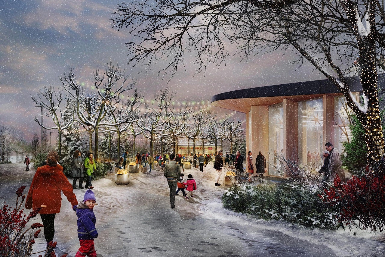 Groups of people enjoying a snowy day an outdoor area with firepits and twinkle lights at dusk.