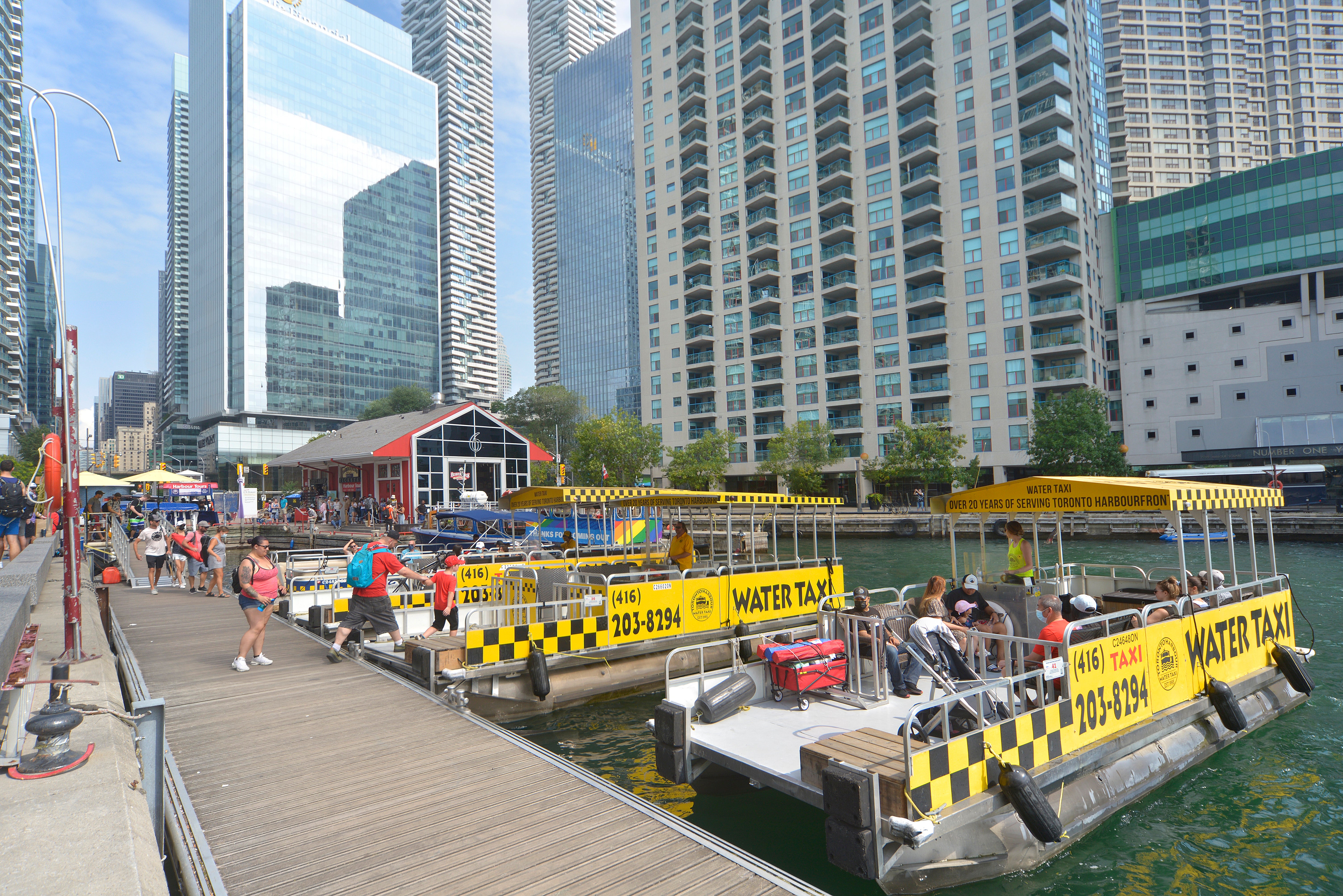 A group of water taxis in a slip on the waterfront. 