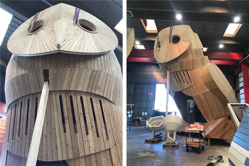 A large owl play structure in a warehouse.