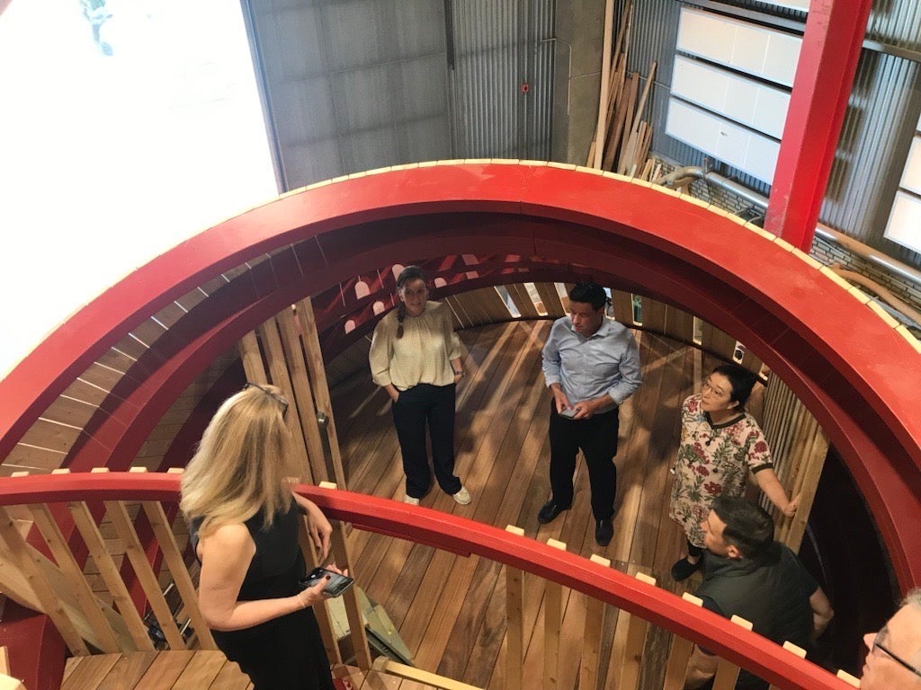 People stand in a large play structure.