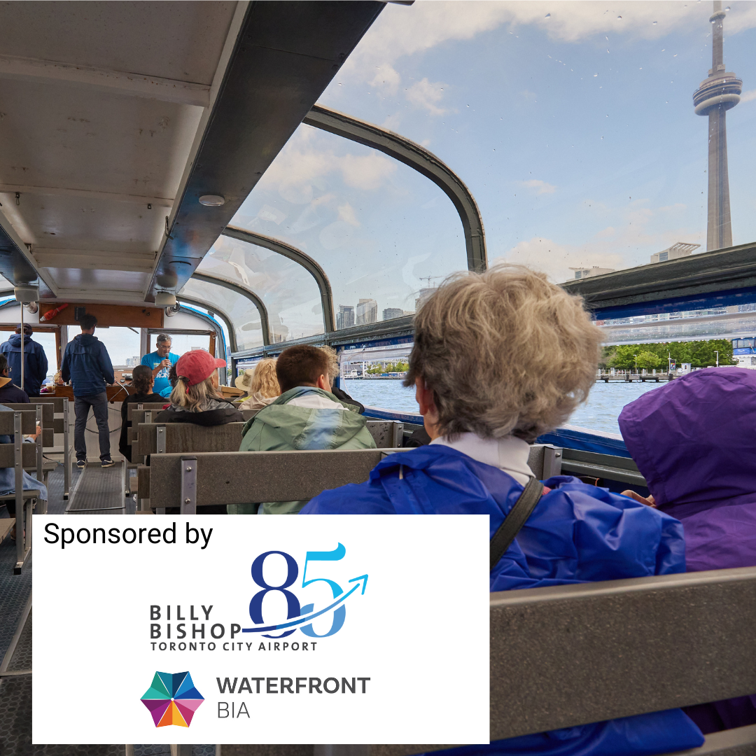 people on a boat tour with the CN tower in the background