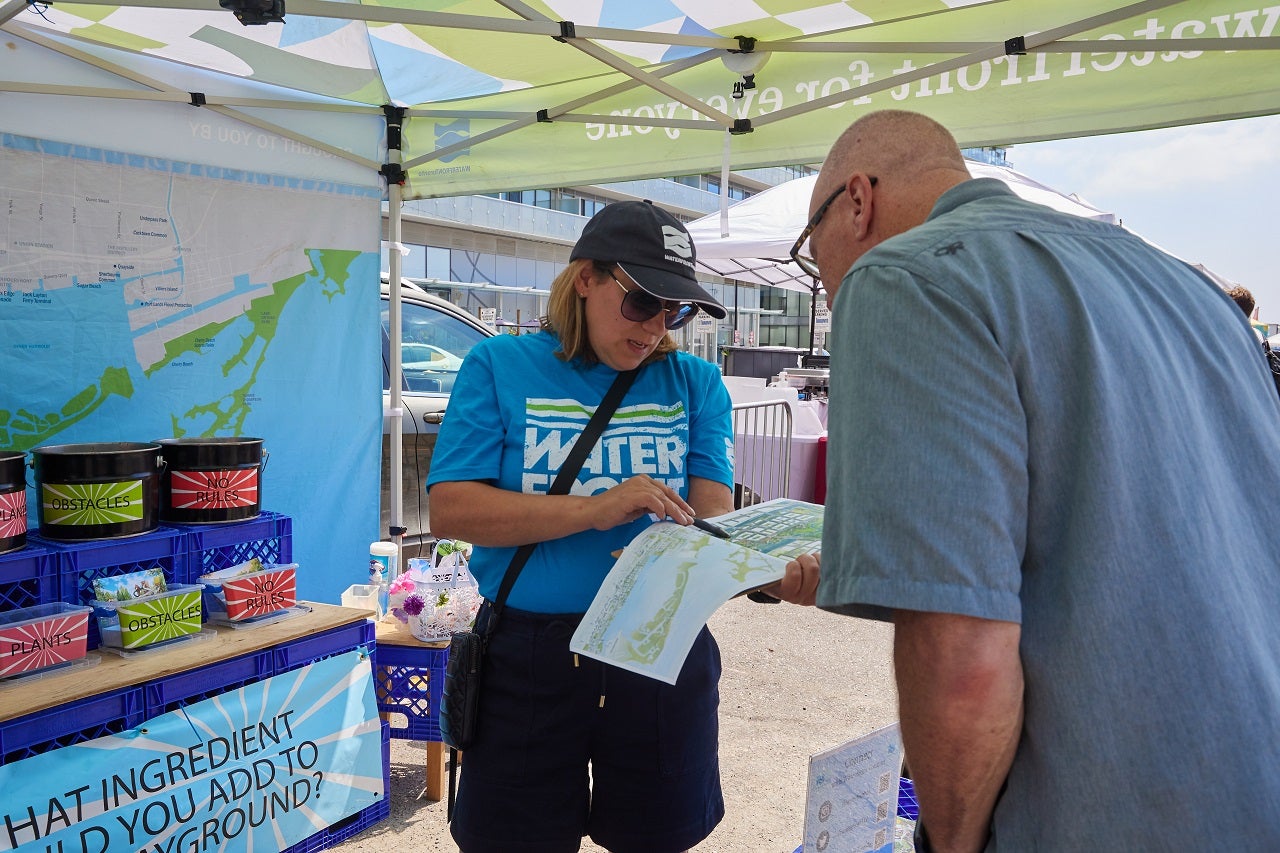 Waterfront Toronto Staff member speaking to someone at a pop-up engagement.
