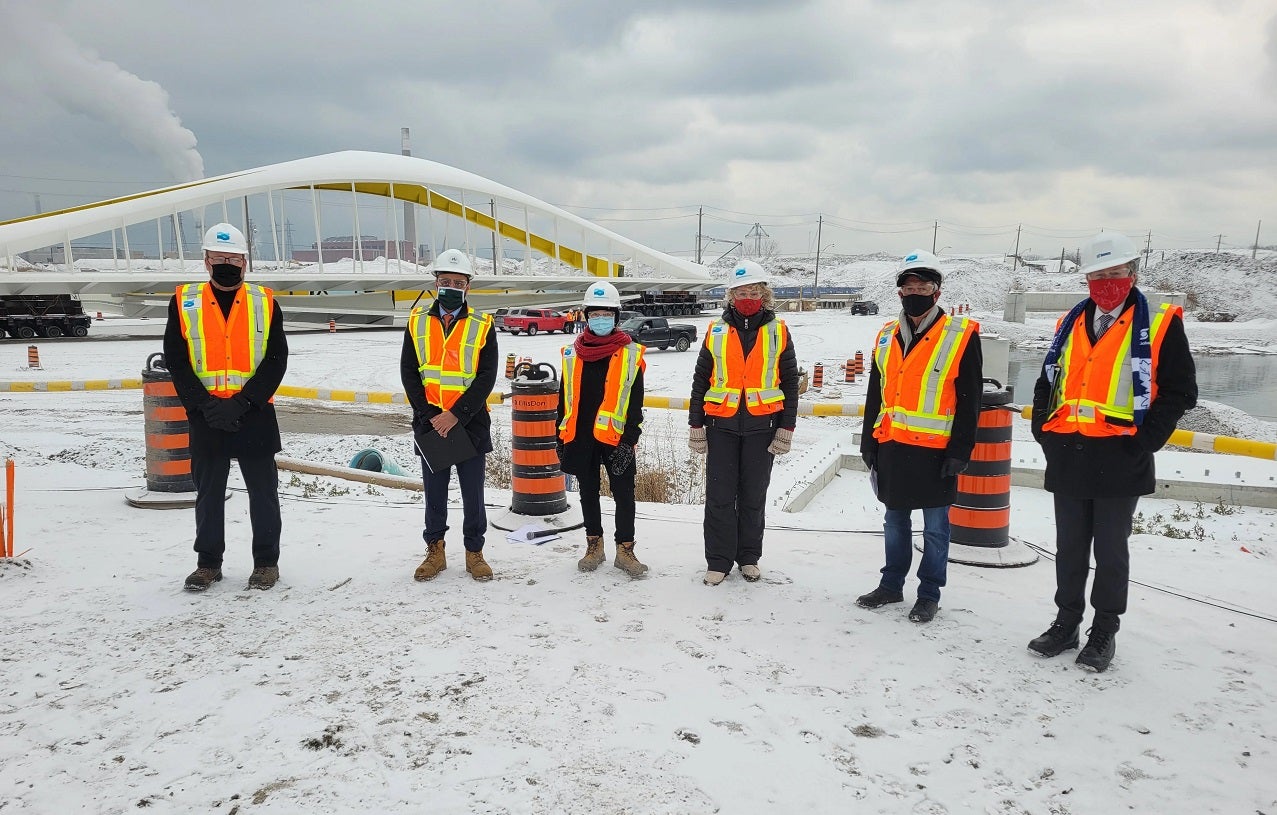 a group of government officials gather at an outdoor event in the winter