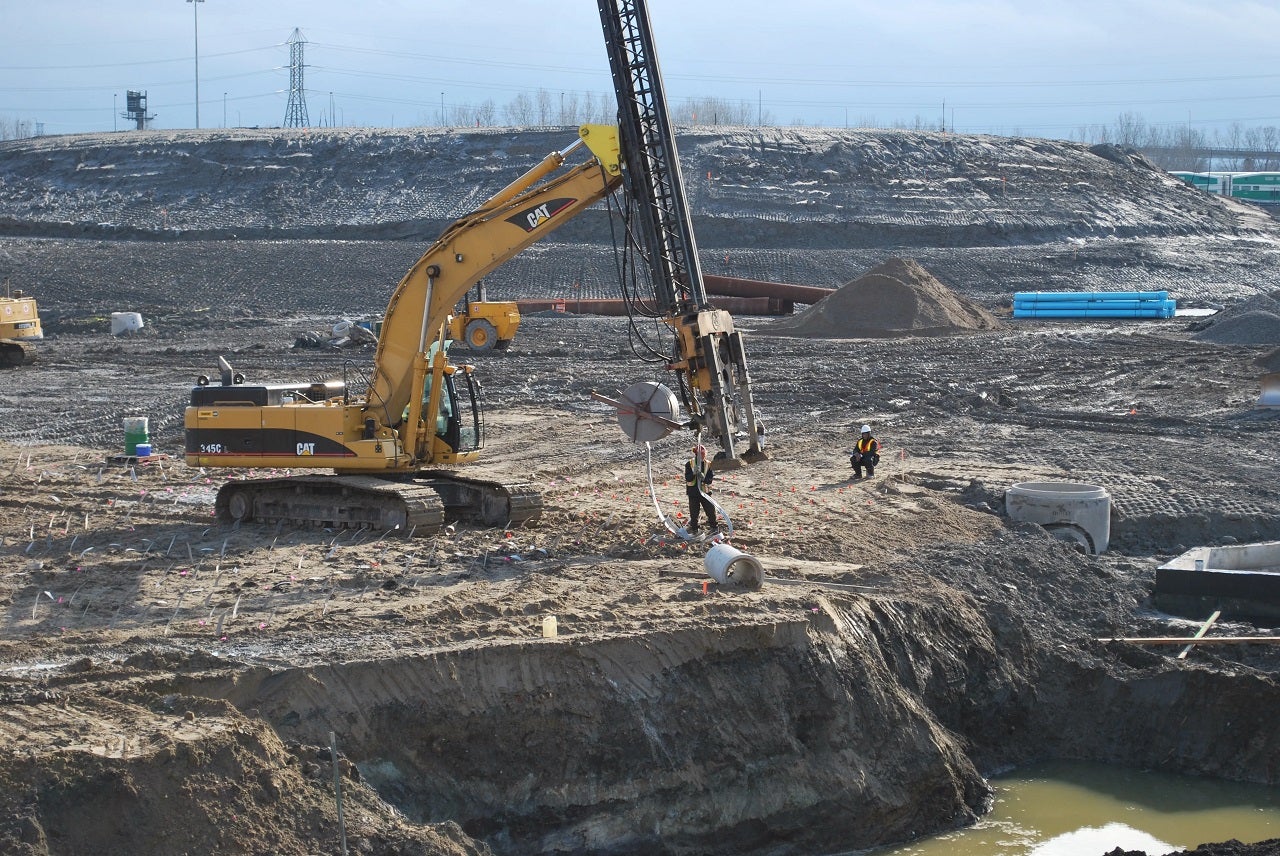 a large active construction site with equipment and crews