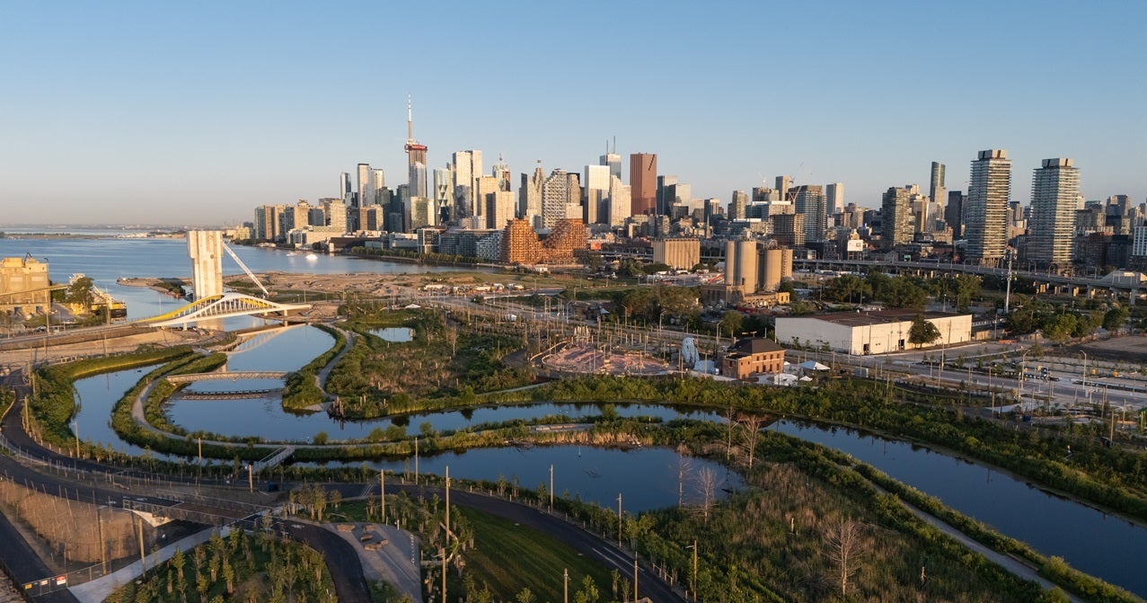 A bird's eye view of Biidaasige Park and Ookwemin Minising with downtown Toronto in the background.