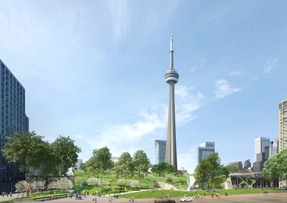 an open green space with the CN Tower in the background