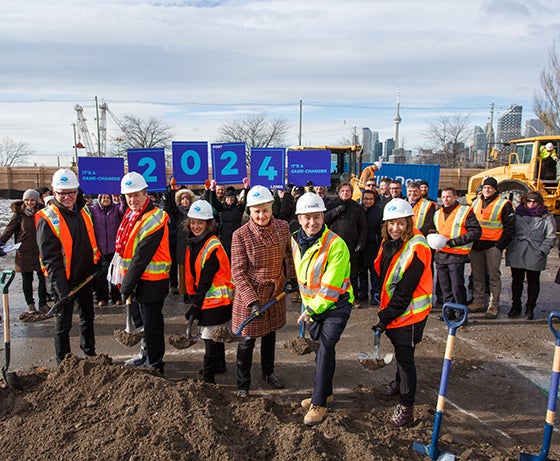 group photo of dignitaries with shovels at a groundbreaking event