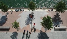 rooftop view looking down at a granite waterfront promenade