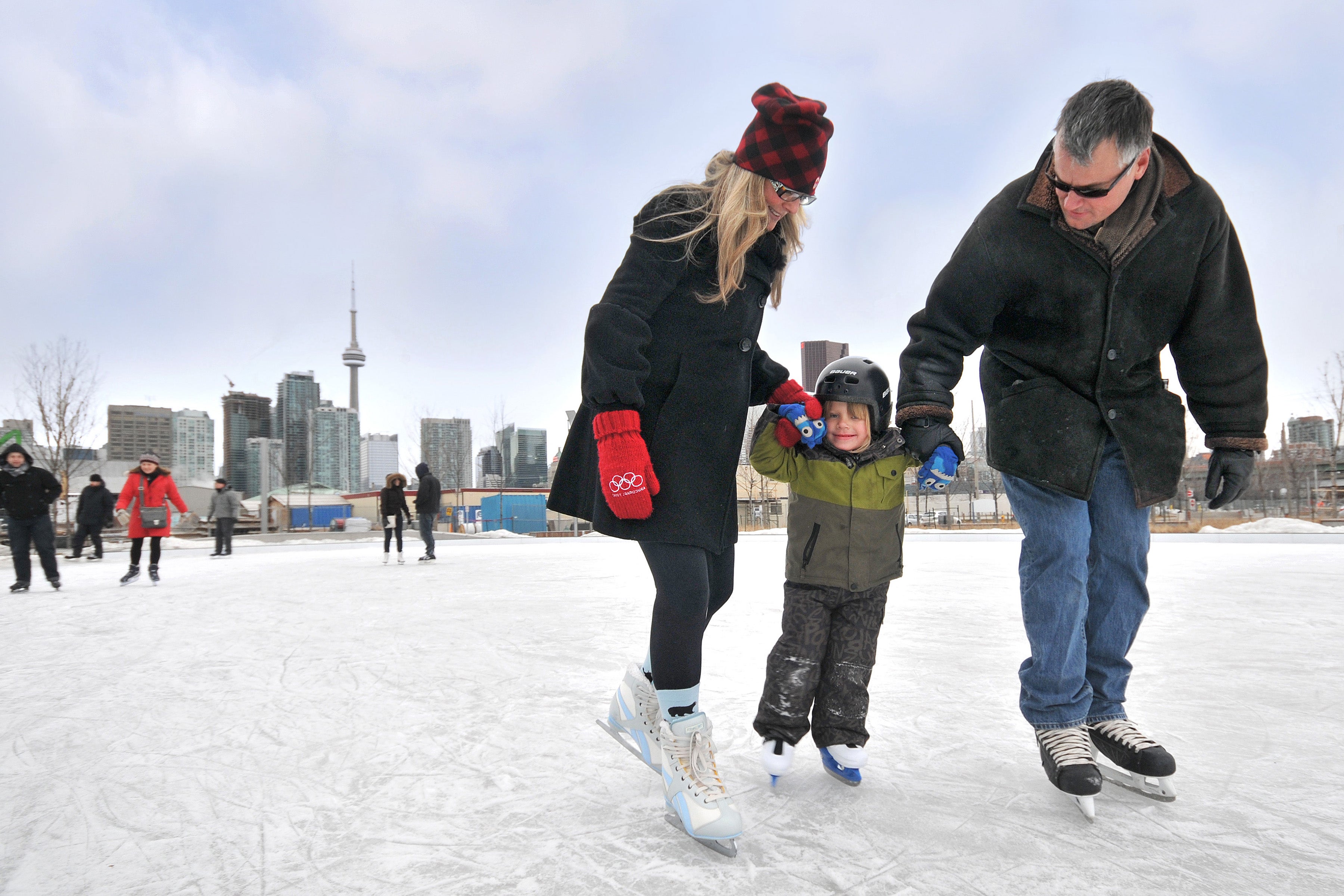 Families skating on the outdoor ice rink at Sherbourne Common.