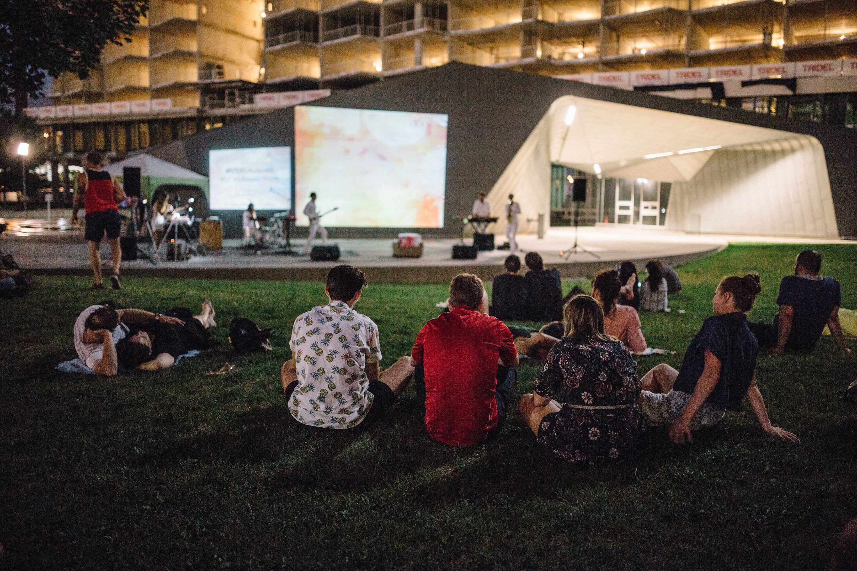 An audience watching audio/visual performance, Versa, at Sherbourne Common.