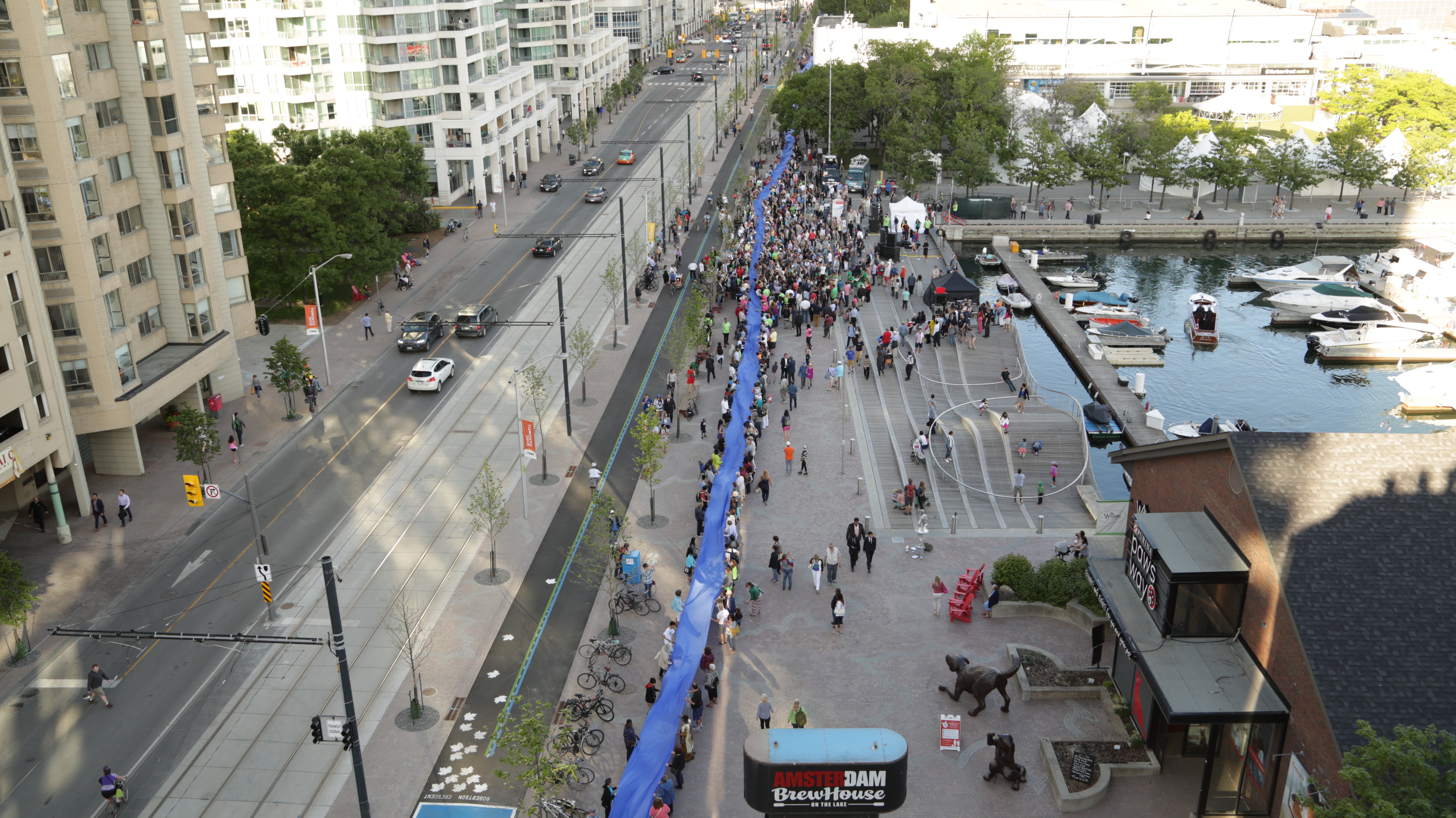 A small section of the 650-metre ribbon passing through the crowd gathered at the Simcoe WaveDeck.