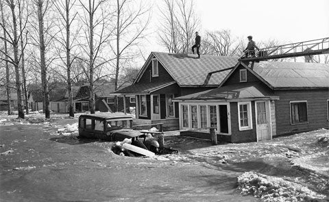 Citizens taking shelter on the roof of their homes as waters flooded the street below.