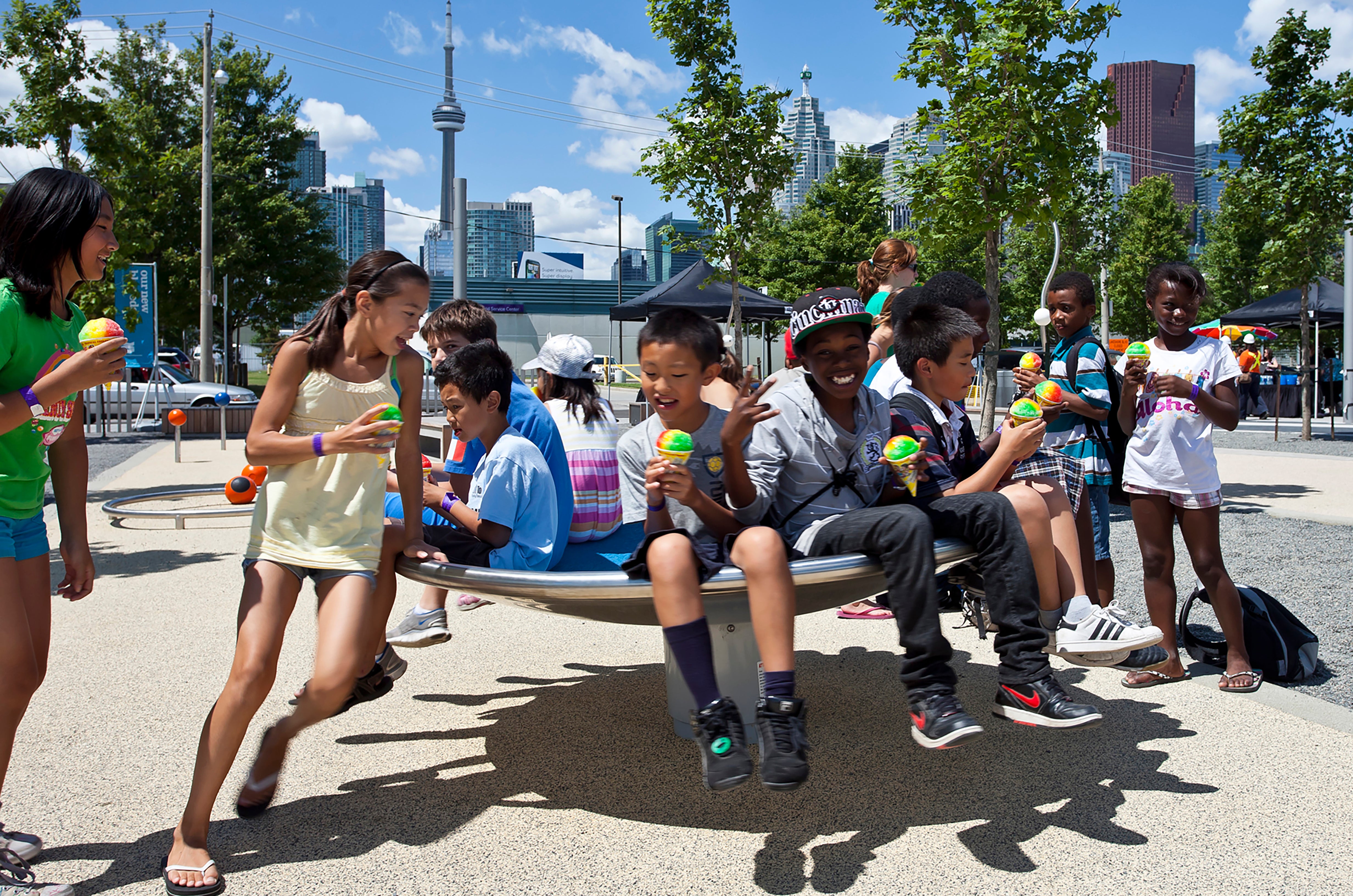 Children playing on the spinning equipment at Sherbourne Common.