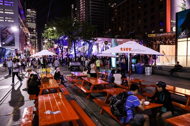 During the Toronto International Film Festival, a section of King Street West was temporarily closed to cars, creating a pedestrian-only space with activities, performances and cafes spilling off the sidewalks.