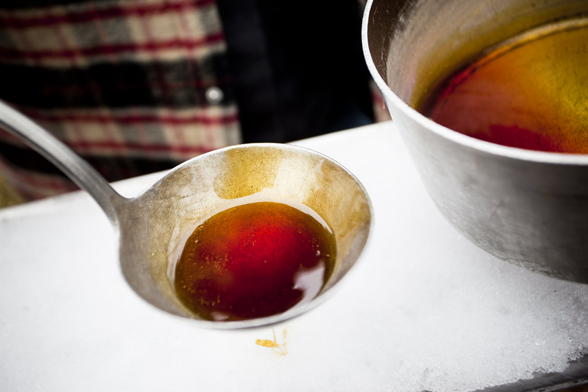 Maple syrup being poured over ice for sampling