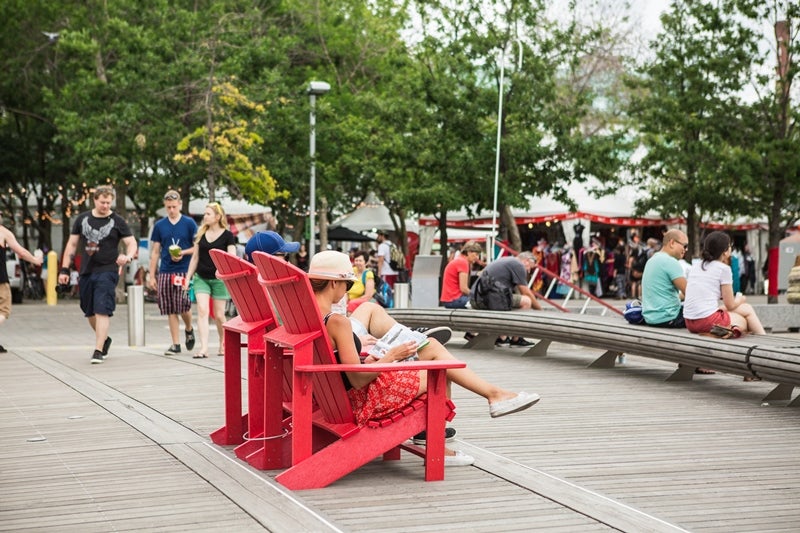 two large red Muskoka chairs on a wavedeck