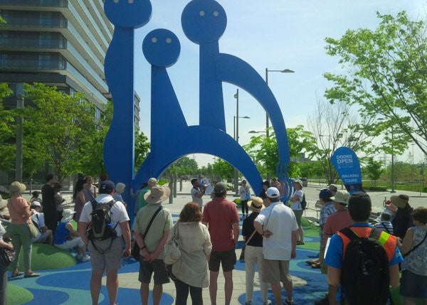 Doors Open participants congregate around The Water Guardians in the West Don Lands.