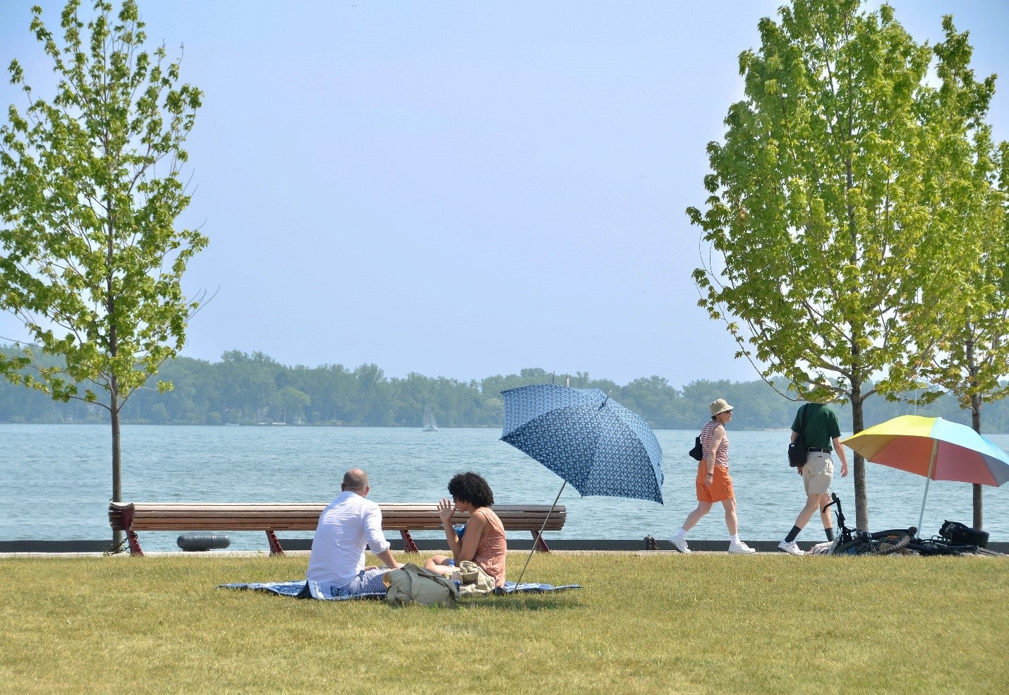 Citizens of Toronto enjoying a pic nic and stroll along the water's edge