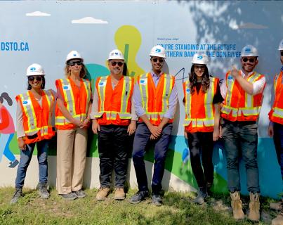 group photo of staff in construction hats and vests