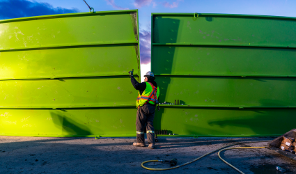 A crew worker building water storage