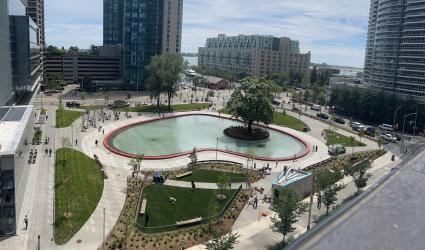 aerial view of an urban park with a large heart shaped pond