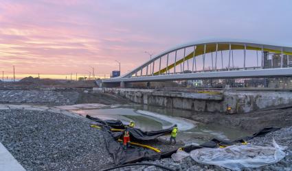 Workers laying plastic to protect river finishes and plants