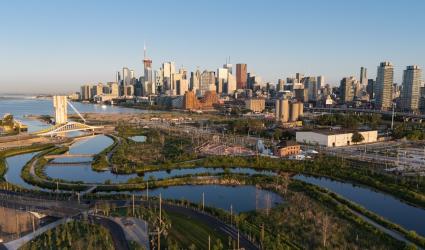 A bird's eye view of Biidaasige Park and Ookwemin Minising with downtown Toronto in the background.