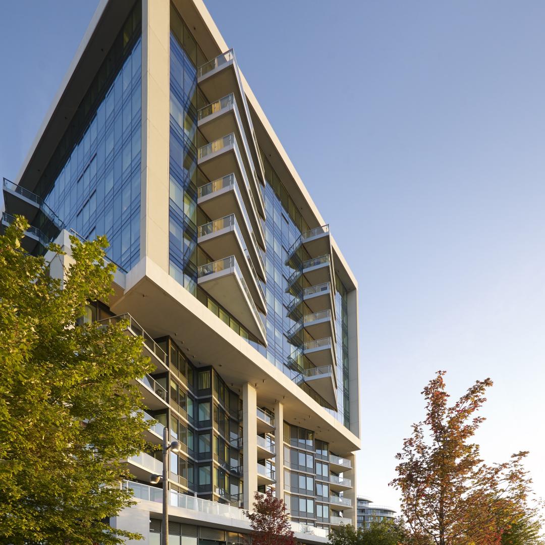 the exterior of a building with trees and landscaping