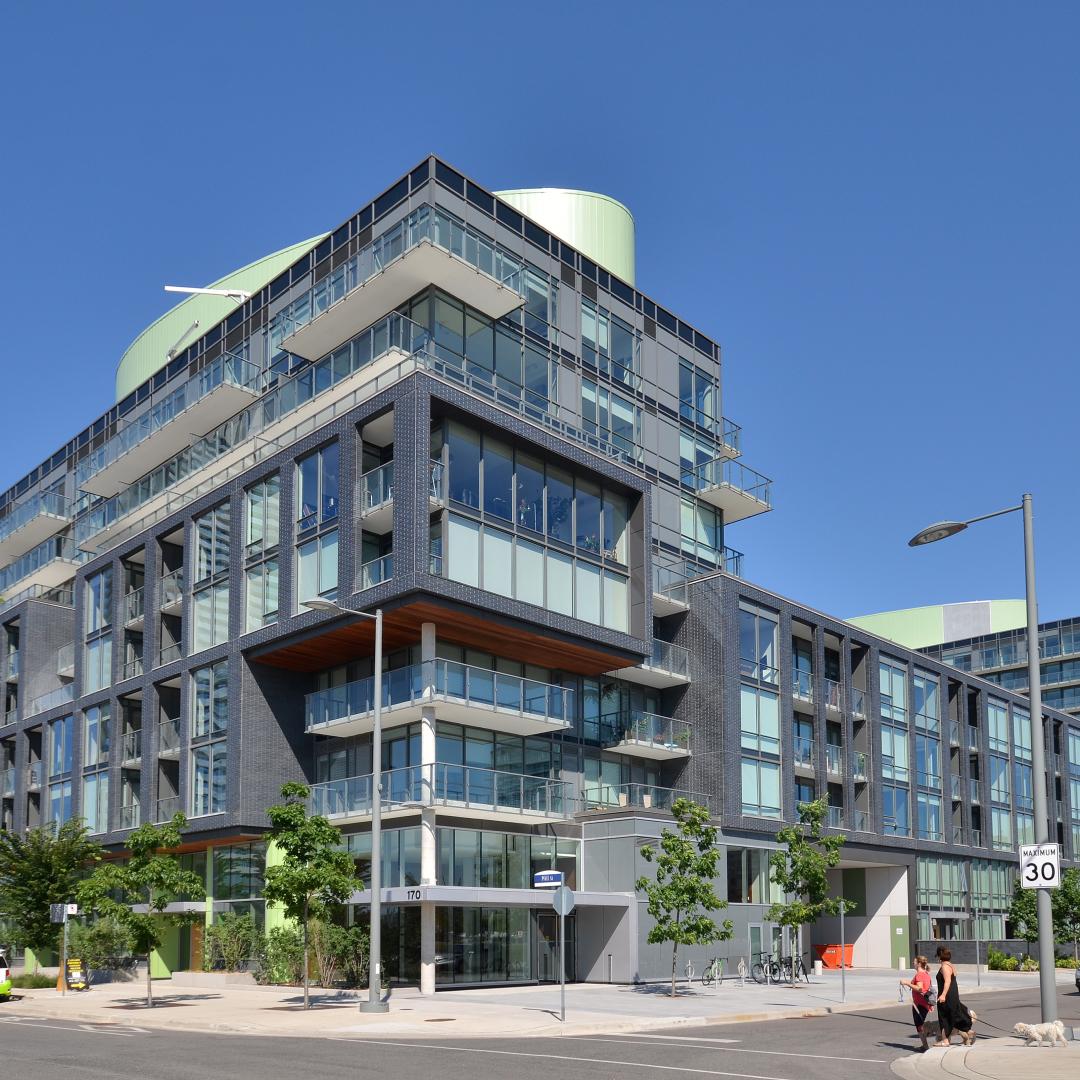 the exterior of a building with cars parked outside