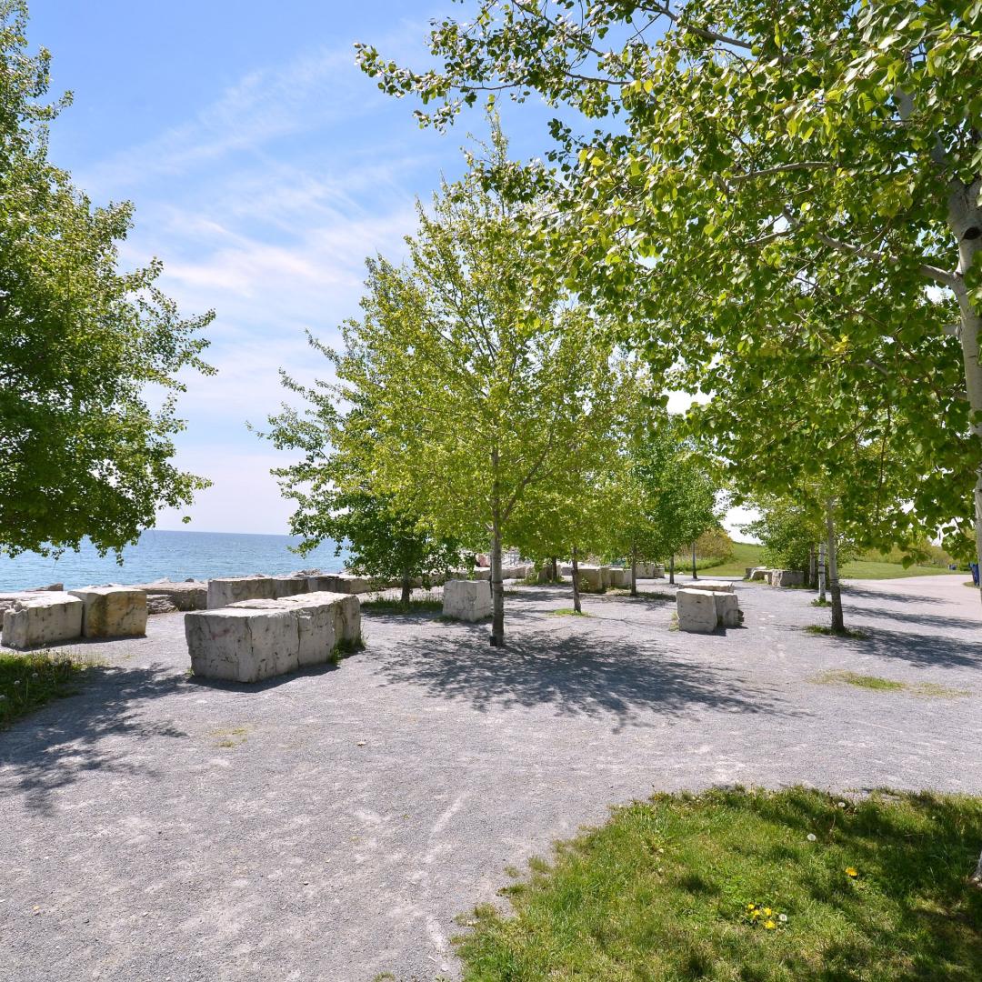 a picnic area with rocks and boulders as seating next to Lake Ontario