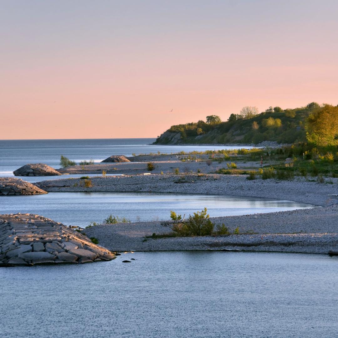 cobblestone beach and Lake Ontario at sunset