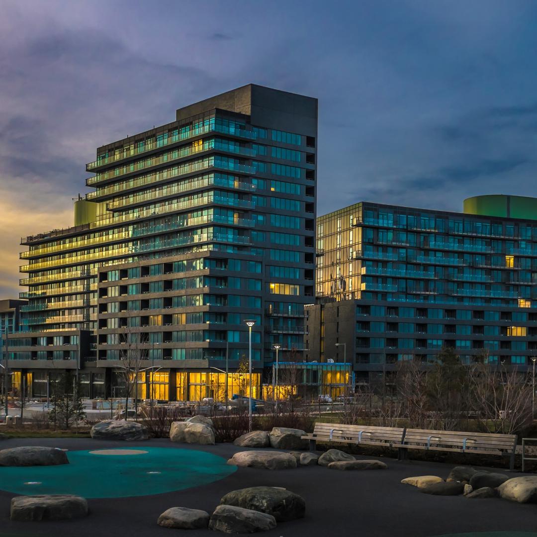 a photo taken at dusk showing condo buildings and a park