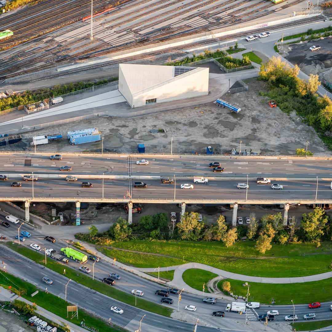 aerial photo showing a construction area and a building next to a highway