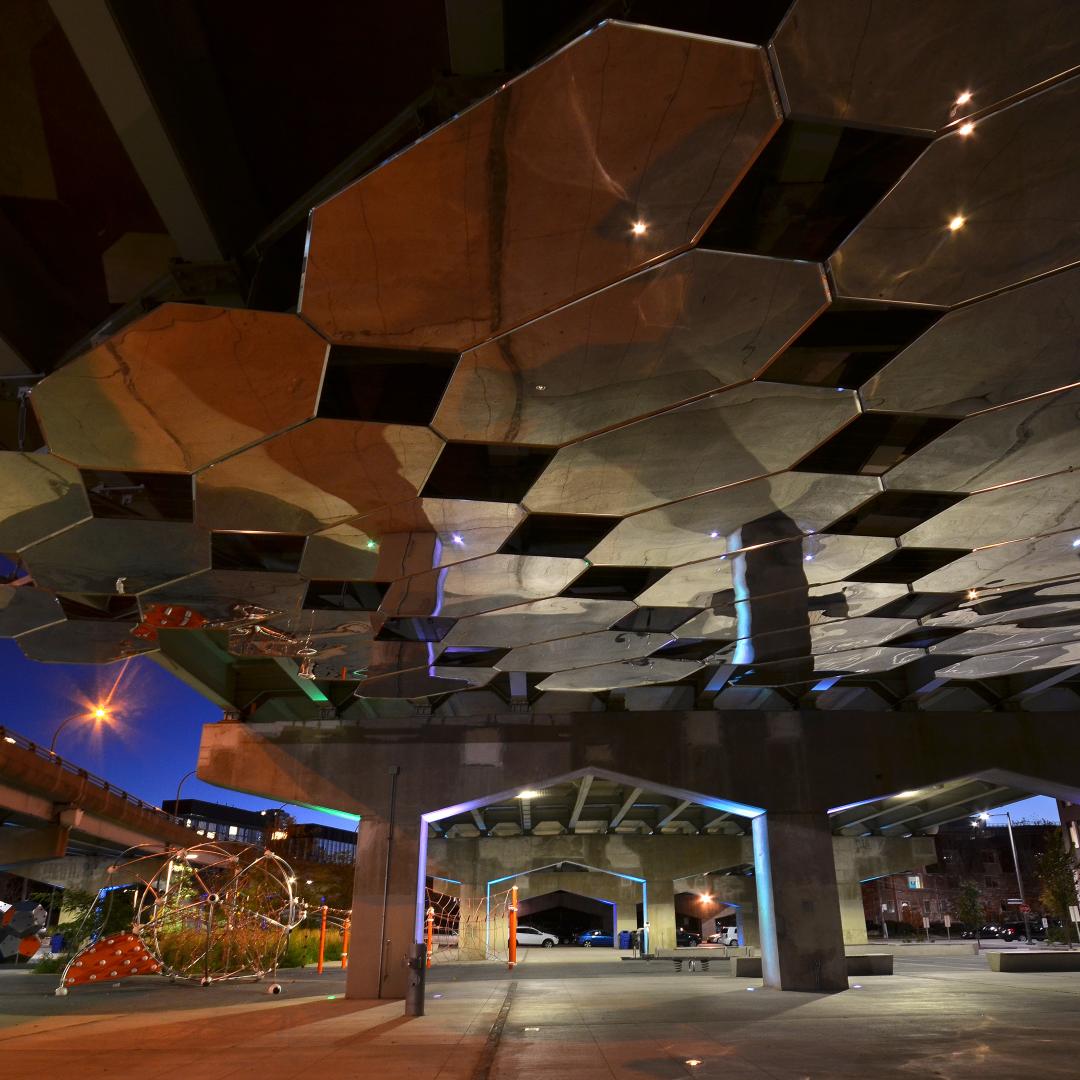 a park at night time showing a public art installation of mirrors